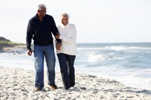 older couple walking along a beach